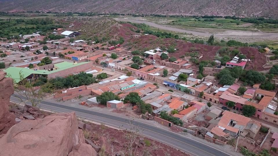 Vista panorámica de un pueblo entre cerros y campos.